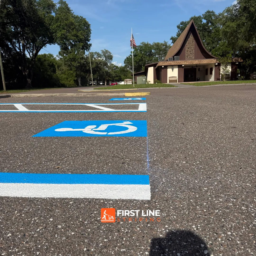 Restriped ADA handicap parking symbols and access aisles in a parking lot in Largo, FL.